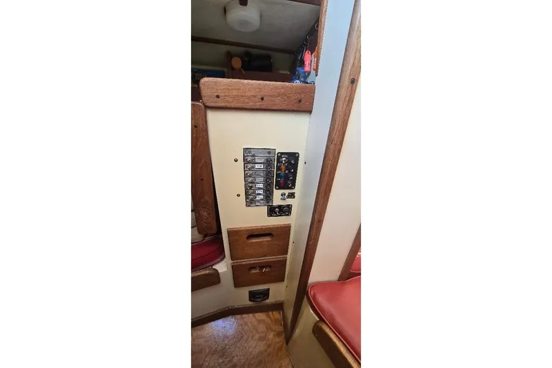 Slide: The Image of 1978 Tartan T34c interior control panel with wooden accents and red seating. - 85
