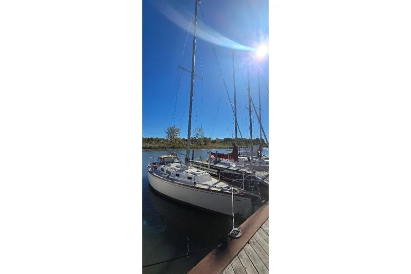 The Image of 1978 Tartan T34c sailboat docked under clear blue sky. - 1
