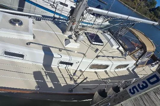 Slide: The Image of 1978 Tartan T34c sailboat docked, showcasing deck and rigging details. - 12