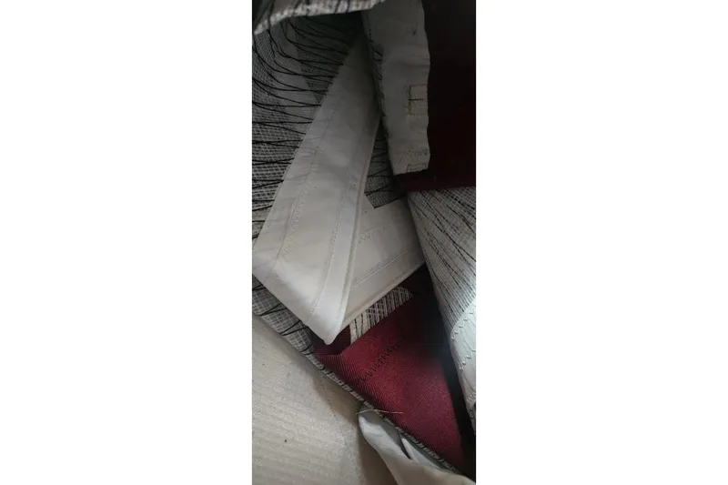 Slide: The Image of Interior view of a 1978 Tartan T34c sailboat, showcasing sails and fabric details. - 34