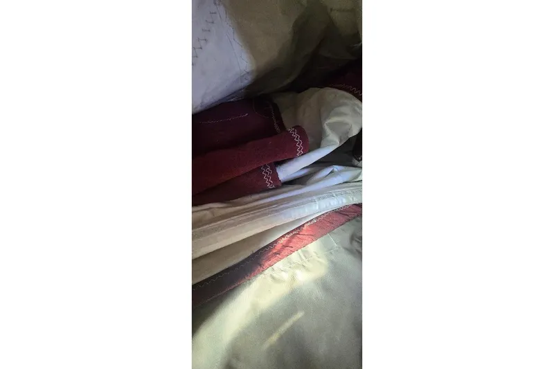 Slide: The Image of Close-up of Tartan T34c 1978 sailboat sails with red and white stitching. - 37