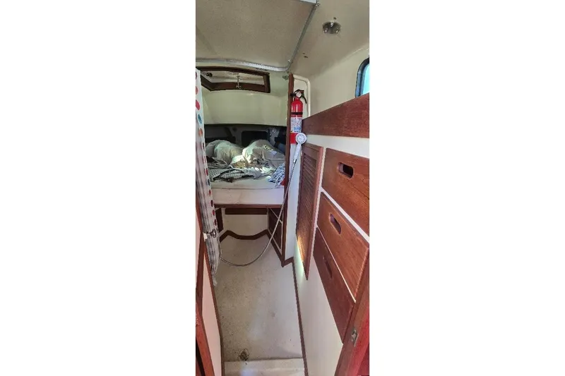 Slide: The Image of Interior of a 1978 Tartan T34c sailboat cabin with wooden storage and bedding. - 42