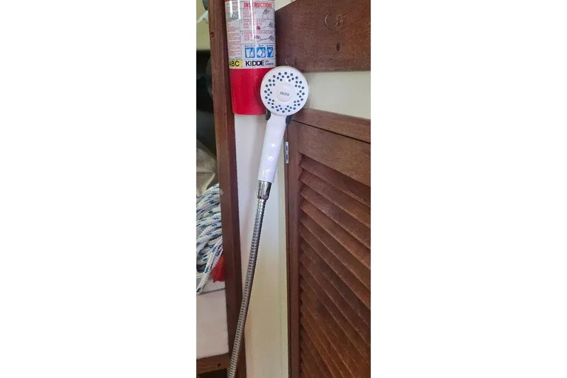Slide: The Image of Showerhead and fire extinguisher in 1978 Tartan T34c sailboat interior. - 43