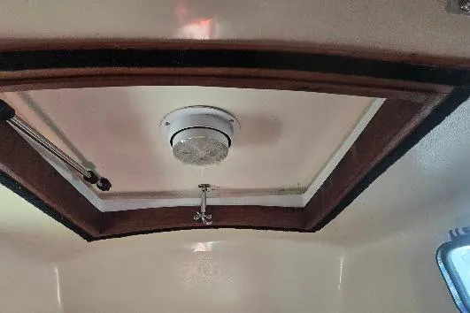 Slide: The Image of Interior ceiling of a 1978 Tartan T34c sailboat with wooden trim and light fixture. - 45