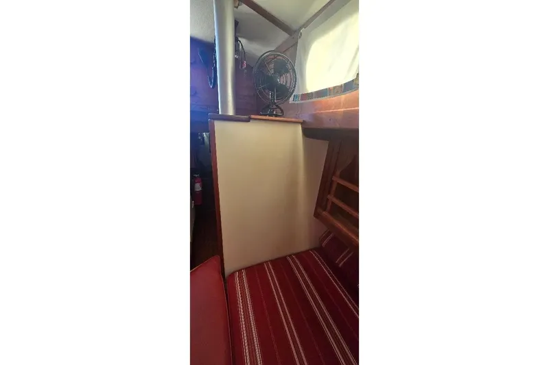 Slide: The Image of Interior of 1978 Tartan T34c sailboat with striped seating and fan. - 49