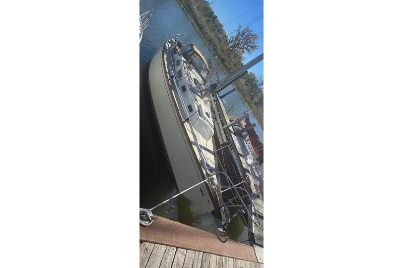 Slide: The Image of 1978 Tartan T34c sailboat docked at a marina, viewed from above. - 5