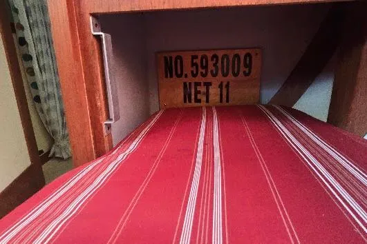 Slide: The Image of Red-striped interior of 1978 Tartan T34c sailboat with identification plaque. - 50