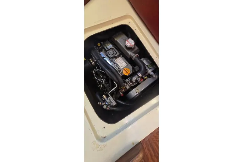 Slide: The Image of Engine compartment of a 1978 Tartan T34c sailboat, showcasing mechanical components. - 58