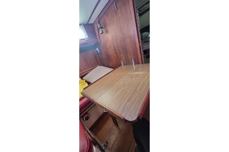 Slide: The Image of Interior of 1978 Tartan T34c sailboat with wooden table and cabinetry. - 68