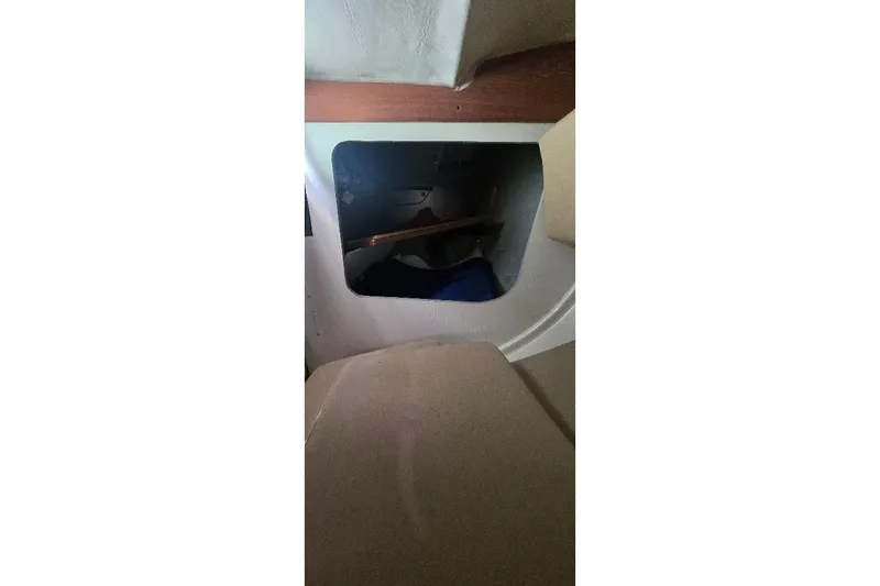 Slide: The Image of Interior view of a 1978 Tartan T34c sailboat, featuring a storage compartment. - 82