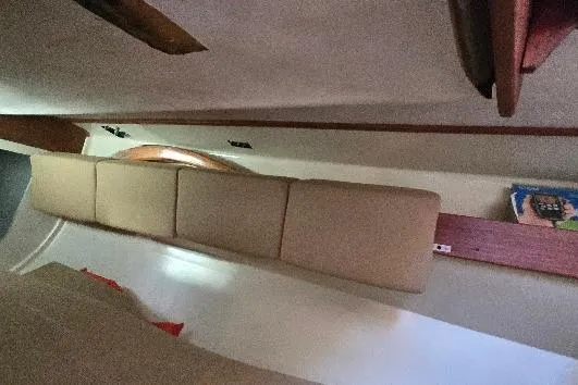 Slide: The Image of Interior of a 1978 Tartan T34c sailboat with beige cushions and wooden accents. - 84