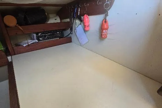 Slide: The Image of 1978 Tartan T34c interior workspace with shelves and hanging keychains. - 86