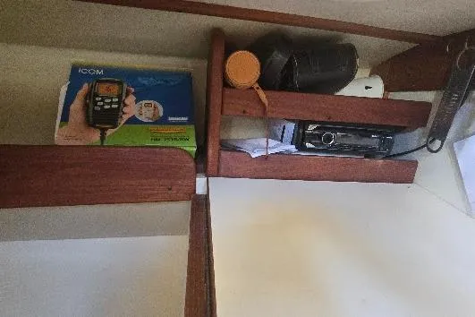 Slide: The Image of Wooden shelves in a 1978 Tartan T34c boat interior with radio equipment. - 87