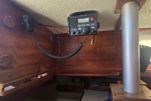 Slide: The Image of Interior of a 1978 Tartan T34c sailboat featuring a mounted radio communication system. - 89