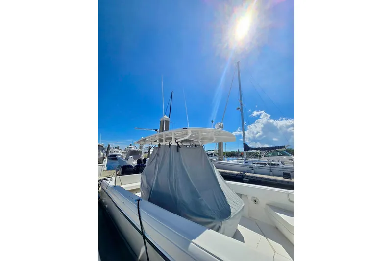 Slide: The Image of 2008 Intrepid 323 OPEN boat docked under bright blue sky. - 4