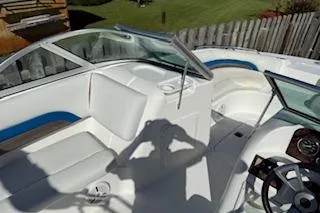 Slide: The Image of 2013 Hurricane SunDeck 187 OB boat interior with white seating and steering wheel. - 10