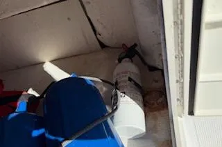 Slide: The Image of 2013 Hurricane SunDeck 187 OB boat interior with fire extinguisher and blue life jackets. - 14