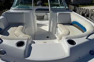 Slide: The Image of 2013 Hurricane SunDeck 187 OB boat interior with white seating and cup holders. - 3