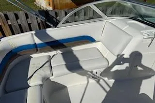 Slide: The Image of 2013 Hurricane SunDeck 187 OB boat interior with white seating and blue accents. - 5