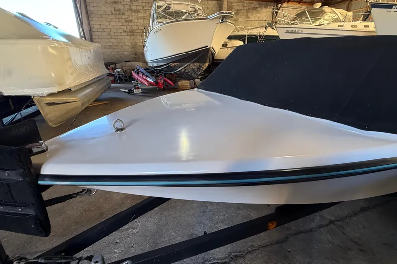 Slide: The Image of 1995 Correct Craft Ski Nautique boat in storage, covered and on a trailer. - 13