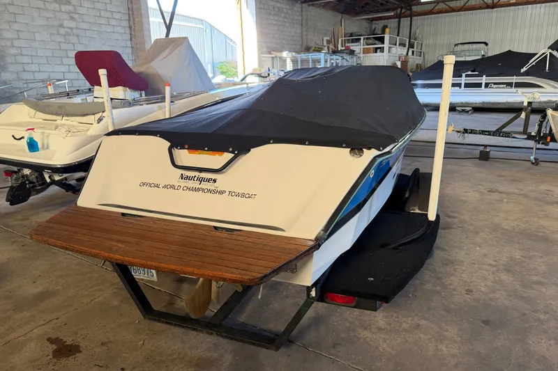 Slide: The Image of 1995 Correct Craft Ski Nautique boat in storage, covered and on a trailer. - 16