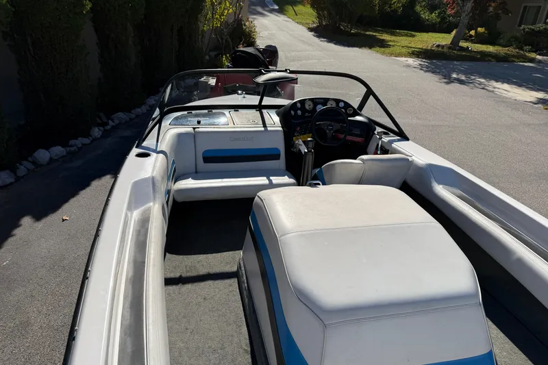 Slide: The Image of 1995 Correct Craft Ski Nautique boat interior with steering wheel and seating. - 20