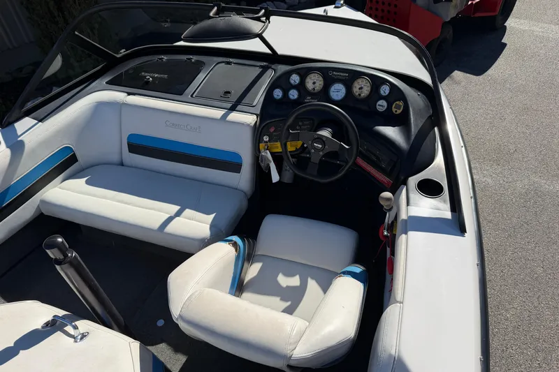 Slide: The Image of 1995 Correct Craft Ski Nautique boat interior with steering wheel and dashboard controls. - 22