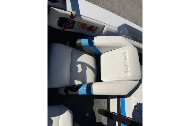 Slide: The Image of 1995 Correct Craft Ski Nautique boat interior with white and blue seating. - 23
