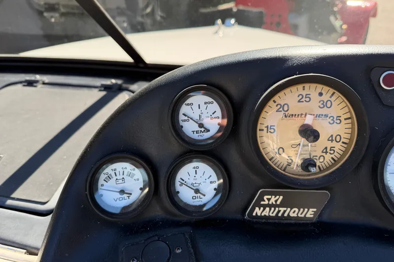 Slide: The Image of Dashboard of a 1995 Correct Craft Ski Nautique boat with gauges and controls. - 33