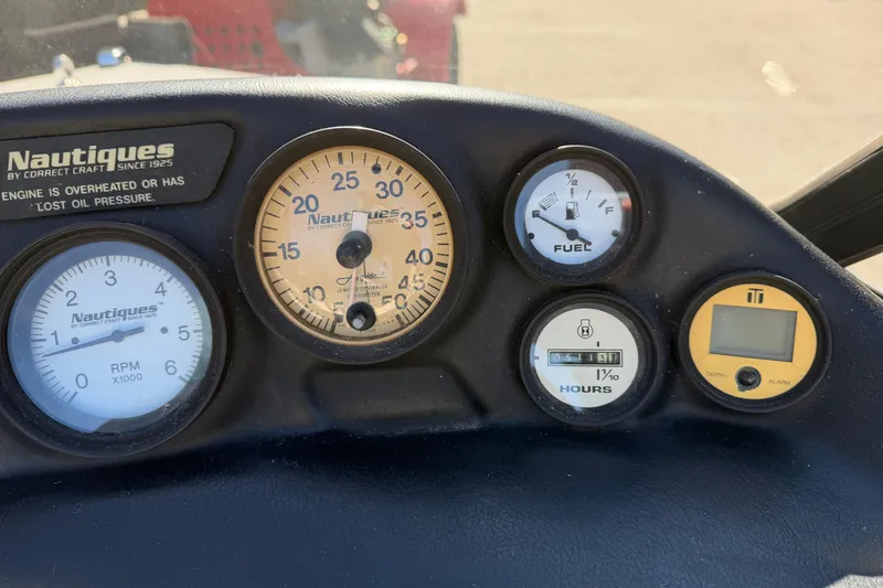 Slide: The Image of Dashboard of a 1995 Correct Craft Ski Nautique with various gauges and indicators. - 34