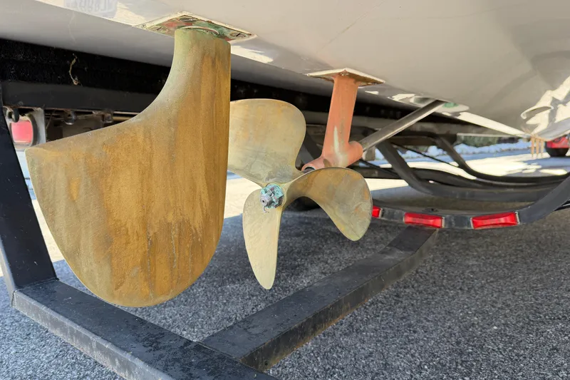 Slide: The Image of 1995 Correct Craft Ski Nautique boat propeller and rudder on trailer. - 38