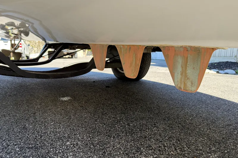 Slide: The Image of 1995 Correct Craft Ski Nautique boat hull with visible rusted fins on a trailer. - 39