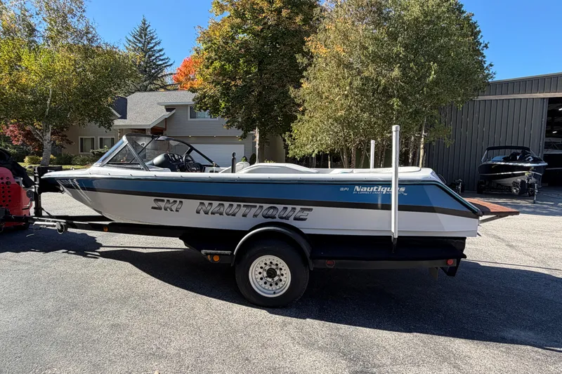 Slide: The Image of 1995 Correct Craft Ski Nautique boat on trailer, parked outdoors. - 4
