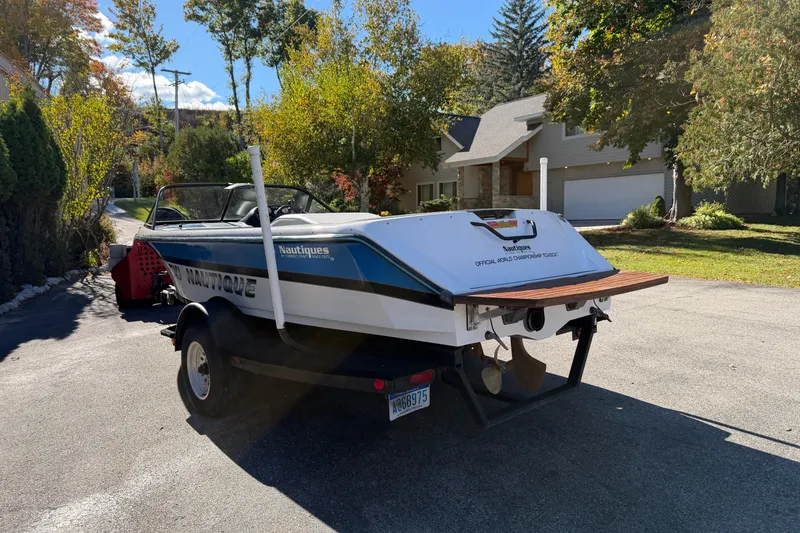 Slide: The Image of 1995 Correct Craft Ski Nautique boat on trailer in suburban driveway. - 5