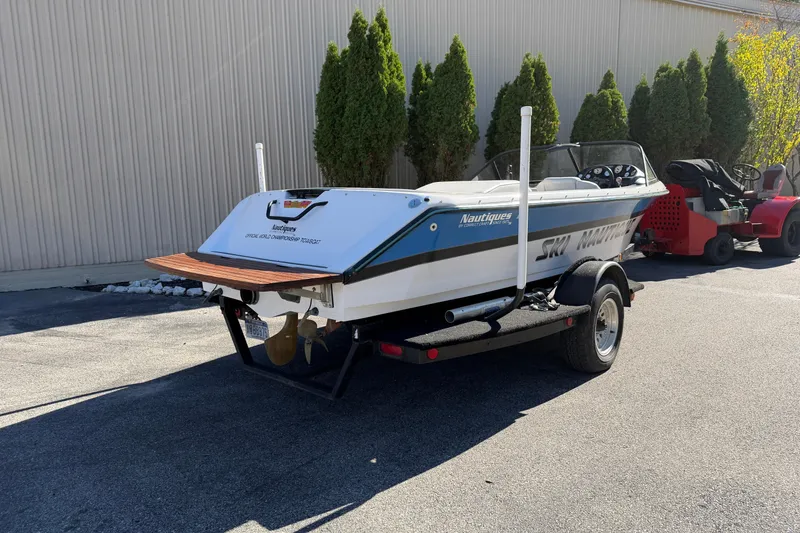 Slide: The Image of 1995 Correct Craft Ski Nautique boat on trailer, parked outdoors near a building. - 7