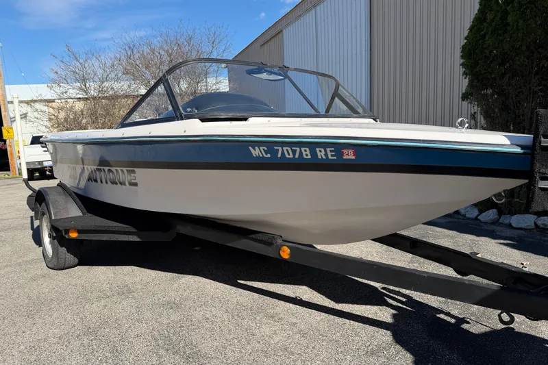 Slide: The Image of 1995 Correct Craft Ski Nautique boat on trailer, parked outdoors. - 8