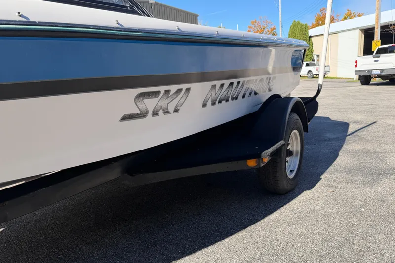 Slide: The Image of 1995 Correct Craft Ski Nautique boat on trailer, parked outdoors. - 9