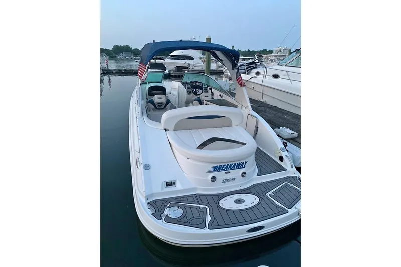 The Image of 2009 Chaparral 256 SSX boat docked, featuring a sleek design and comfortable seating. - 1