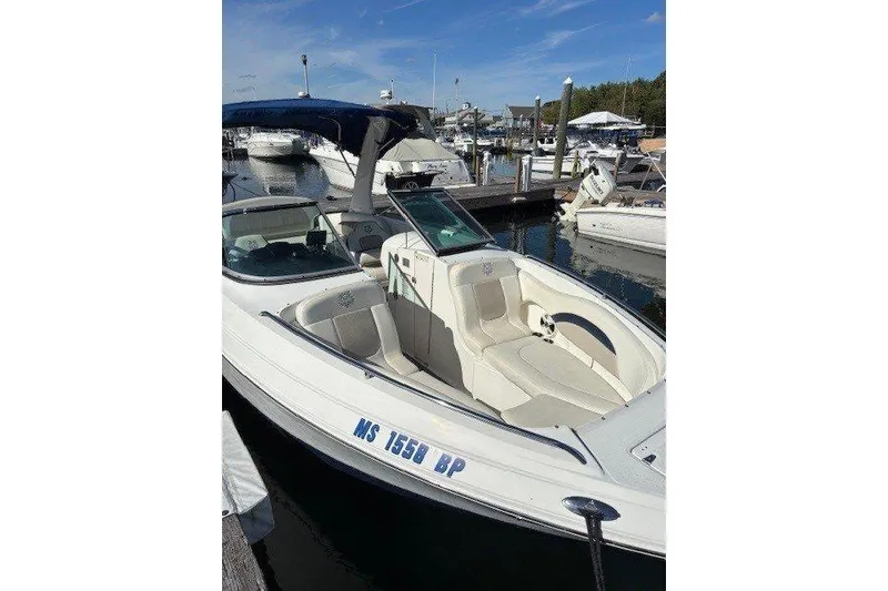 Slide: The Image of 2009 Chaparral 256 SSX boat docked at marina under clear blue sky. - 3