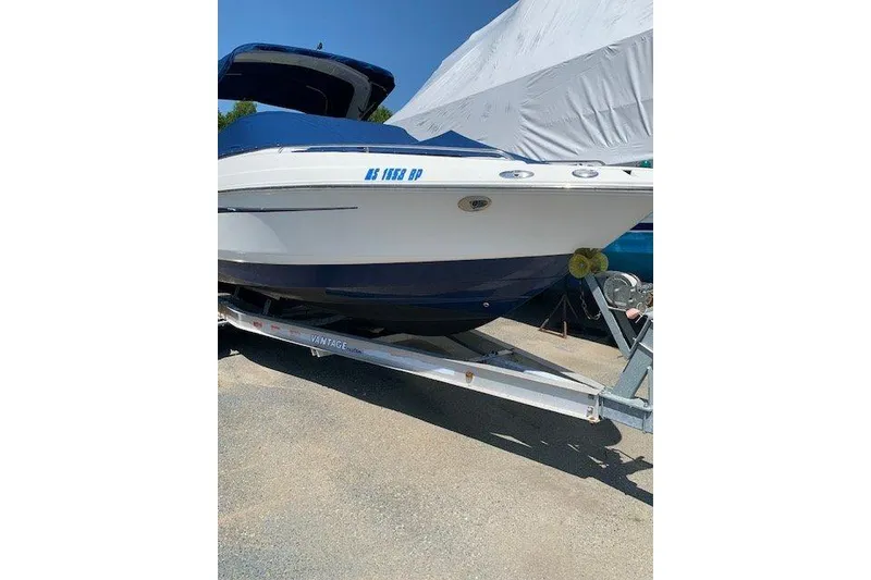 Slide: The Image of 2009 Chaparral 256 SSX boat on trailer, covered and parked outdoors. - 7