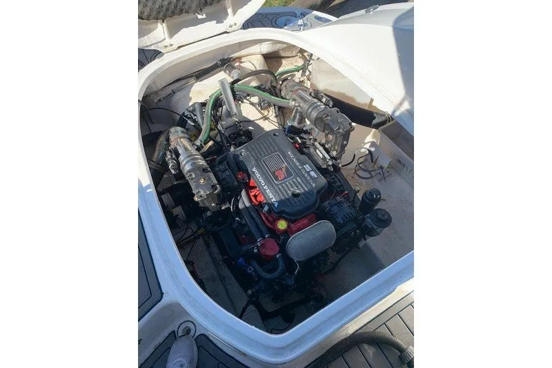 Slide: The Image of 2009 Chaparral 256 SSX boat engine compartment with visible engine components. - 8