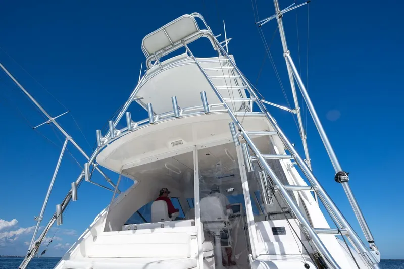 Slide: The Image of 2012 Cabo 40 Hardtop Express yacht with tower against clear blue sky. - 12