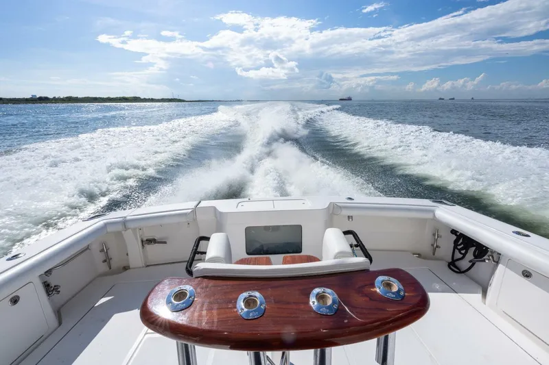 Slide: The Image of 2012 Cabo 40 Hardtop Express cruising on open water, leaving a wake behind. - 14