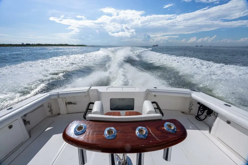Slide: The Image of 2012 Cabo 40 Hardtop Express cruising on open water, leaving a wake behind. - 15
