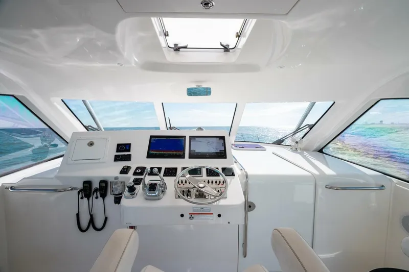 Slide: The Image of Helm of 2012 Cabo 40 Hardtop Express yacht with modern navigation equipment. - 25
