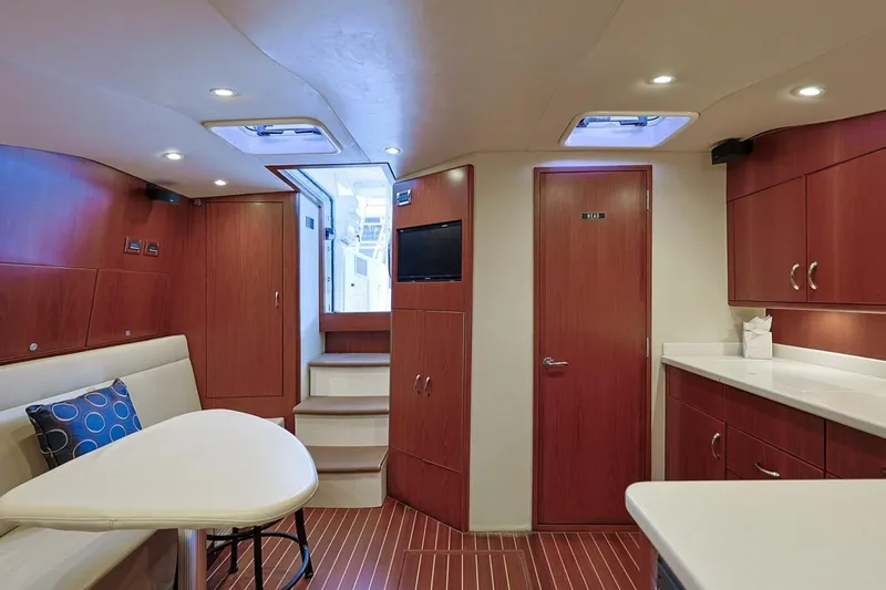 Slide: The Image of Luxurious interior of 2012 Cabo 40 Hardtop Express yacht with wood finish and modern amenities. - 30