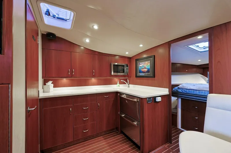 Slide: The Image of Luxurious interior of 2012 Cabo 40 Hardtop Express yacht with modern kitchen and cozy cabin. - 32