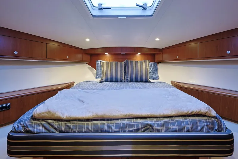 Slide: The Image of Luxurious cabin interior of 2012 Cabo 40 Hardtop Express yacht with cozy bedding. - 33