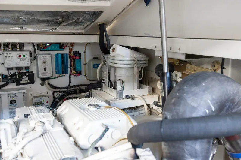 Slide: The Image of Engine room of a 2012 Cabo 40 Hardtop Express, showcasing mechanical components and wiring. - 44