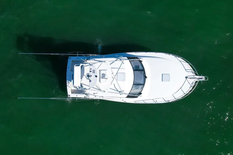 Slide: The Image of Overhead view of 2012 Cabo 40 Hardtop Express boat on green water. - 52